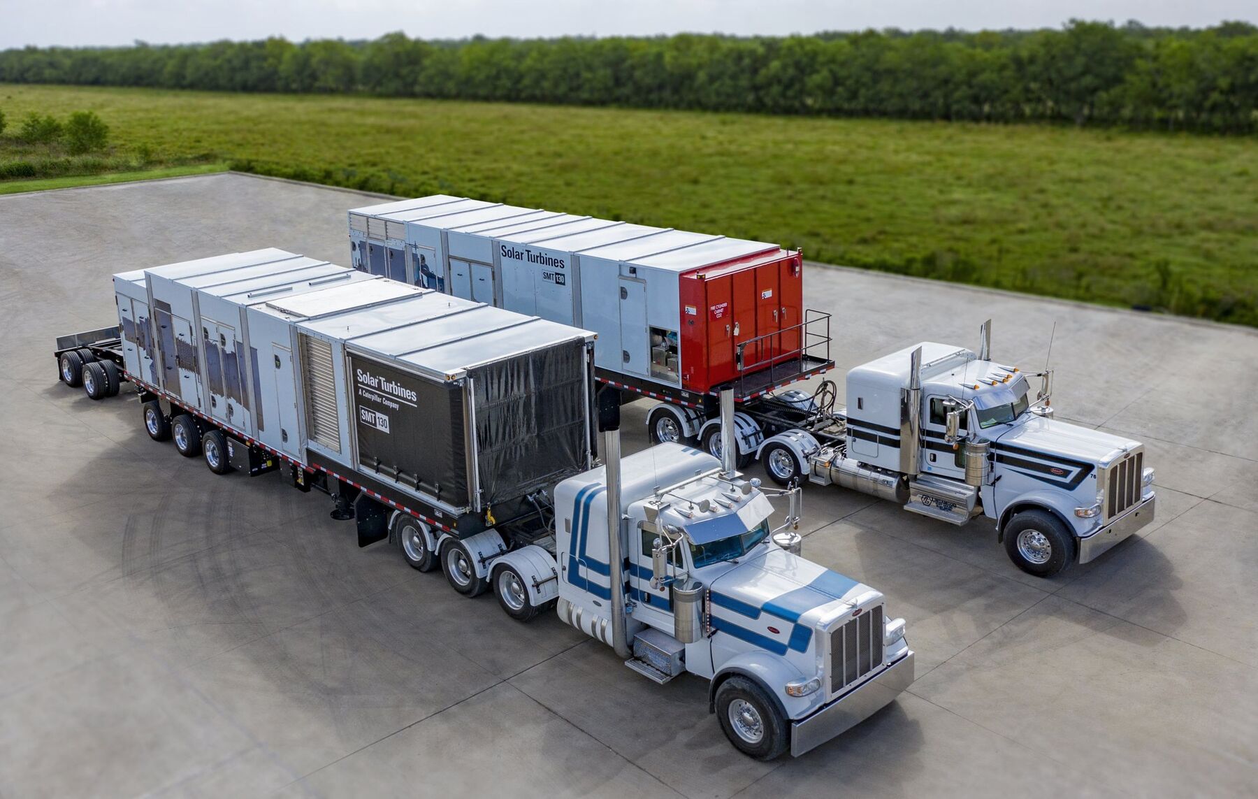 Two trailer-mounted gas turbine generator packages staged with transport tractors